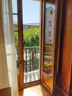 an open door to a balcony with a view at Pension a Fontiña in Cuntis