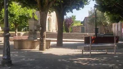 a park with a bench and a street light at Pension a Fontiña in Cuntis
