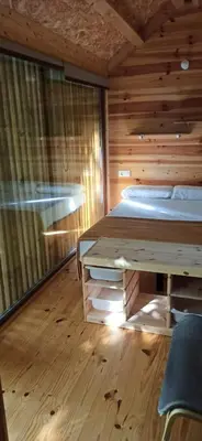 a bedroom with a bed and a desk in a room at Balneario Acuña in Caldas de Reis