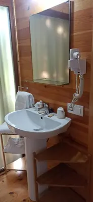 a bathroom with a white sink and a mirror at Balneario Acuña in Caldas de Reis