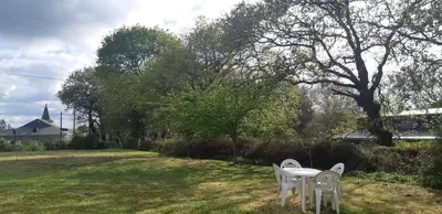 two white chairs and a table in a yard at Casa de Corbelle in Muimenta