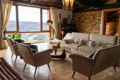 a living room with a couch and chairs at Complejo Rural Lar de Vies in A Pontenova