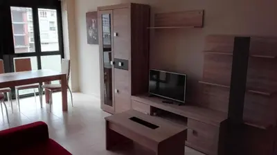 a living room with a tv and a couch and a table at Apartment Javier in Foz