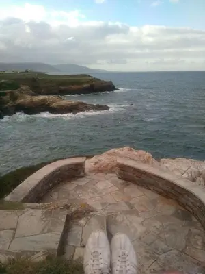 a pair of shoes sitting on a rock near the ocean at Apartment Javier in Foz