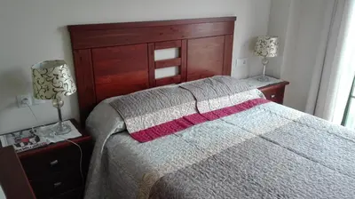 a bedroom with a large bed and two night stands at Apartment Javier in Foz