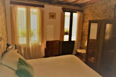a bedroom with a bed and two windows and a bed sidx sidx sidx at Casa Apilladeira in Puentedeume