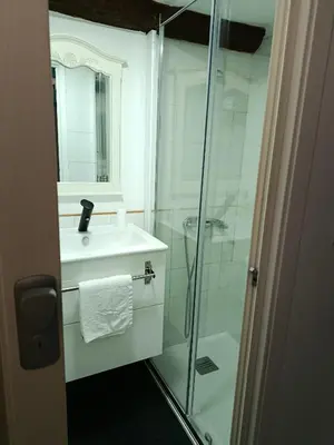 a bathroom with a glass shower and a sink at Casa Apilladeira in Puentedeume