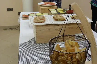 a table with a basket of bread and sandwiches at Hotel Nordés in Burela de Cabo