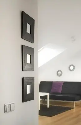 a bedroom with black frames on the wall at Ático Lobariñas in Allariz