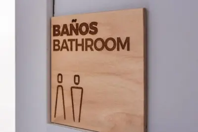 a wooden sign with the words bans bathrooms on it at Santiago KM-0 in Santiago de Compostela