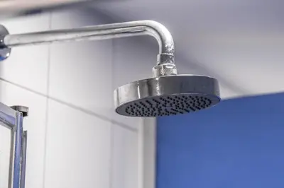 a shower head in a bathroom next to a wall at Santiago KM-0 in Santiago de Compostela