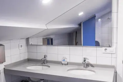 a bathroom with two sinks and a large mirror at Santiago KM-0 in Santiago de Compostela