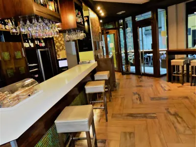 a bar in a restaurant with stools at Hotel Spa Galatea in Burela de Cabo
