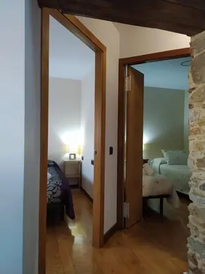 a room with a door open to a bedroom at Casa das Pozas in Distriz