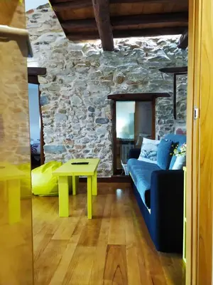 a living room with a couch and a table at Casa das Pozas in Distriz