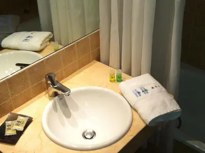 a bathroom with a white sink and a mirror at Hotel Restaurante San Anton in Tapia de Casariego