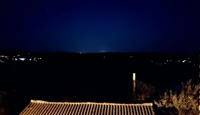 a night view of a house with a mountain in the background at Arzúa Home in Arzúa