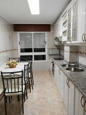 a kitchen with a table and chairs and a sink at Arzúa Home in Arzúa