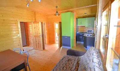 a kitchen with green and blue cabinets in a cabin at CABAÑAS LAGO DE SANABRIA in Vigo de Sanabria