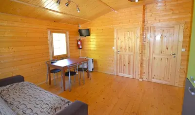 a room with a desk and a table in a cabin at CABAÑAS LAGO DE SANABRIA in Vigo de Sanabria