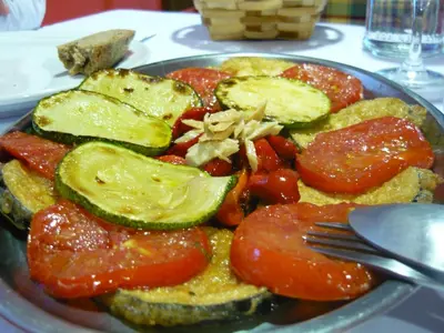 a plate of food with vegetables on a table at Hotel Rural Suquin in Navia