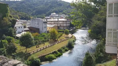 a view of a river in a city with buildings at Casa do Catalán - Casa completa - Navia de Suarna in Navia de Suarna