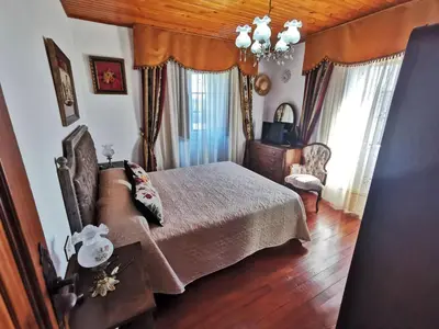 a bedroom with a bed and a couch at Casa de Cacheiro - Silleda in Silleda