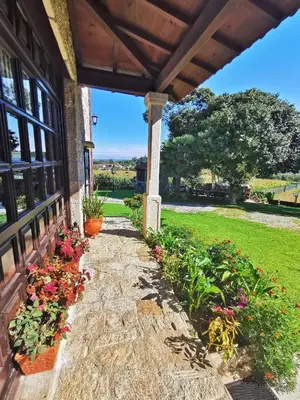 a porch of a house with flowers on it at Casa de Cacheiro - Silleda in Silleda