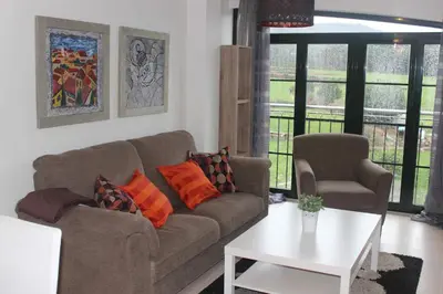a living room with a couch and a table at Costa Reinante Spa in Barreiros