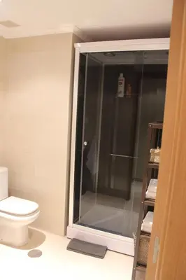 a bathroom with a toilet and a glass shower at Costa Reinante Spa in Barreiros