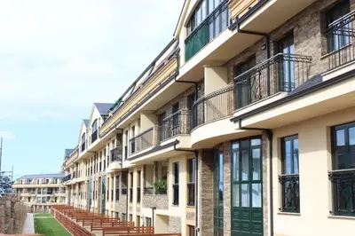 a row of apartment buildings with balconies at Costa Reinante Spa in Barreiros