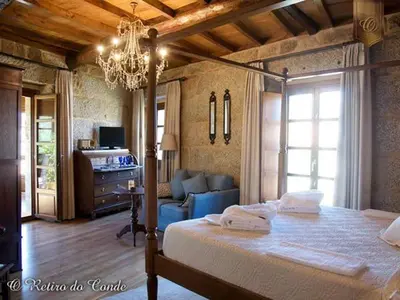 a bedroom with a bed and a living room at O Retiro do Conde in Villaza