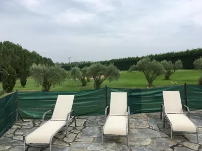 a group of chairs sitting in front of a fence at Hotel Casa Cachón in Tol