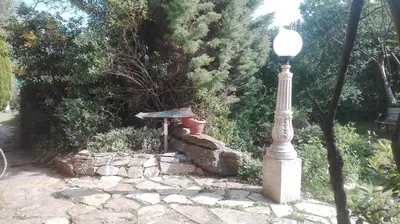 a street light next to a stone wall at Casa rural osvilares in Santiago de Compostela