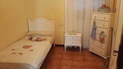 a small bedroom with a bed and a dresser at Casa Rustica Neiro in Santiago de Compostela