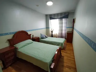 a small room with two beds and a window at Apartamento en Sada in Santa María