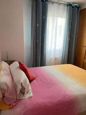 a bedroom with a bed with three pillows on it at Apartamento en Sada in Santa María