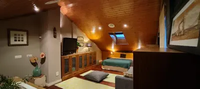a living room with a couch and a television at HHC - Holidays House Compostela in Santiago de Compostela