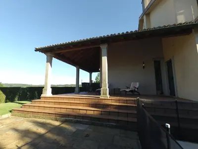 a patio with awning on top of a house at HHC - Holidays House Compostela in Santiago de Compostela