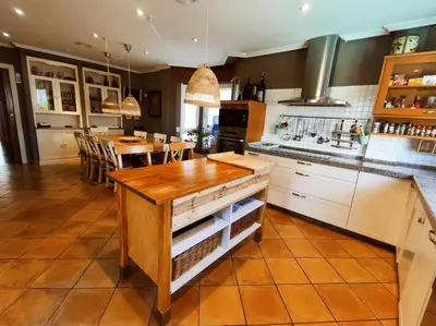 a kitchen with a wooden counter top and a table at HHC - Holidays House Compostela in Santiago de Compostela