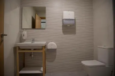 a bathroom with a sink and a toilet at Hostel Cross in Lugo