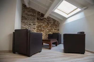 a row of chairs in a room with a skylight at Hostel Cross in Lugo