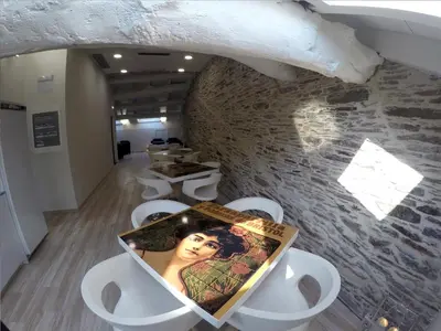 a room with white chairs and a picture on a table at Hostel Cross in Lugo