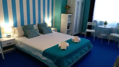 a bedroom with a large bed with two towels on it at Pensión Mar Azul in Santiago de Compostela