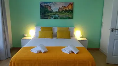 a bedroom with a bed with two white pillows at Pensión Mar Azul in Santiago de Compostela