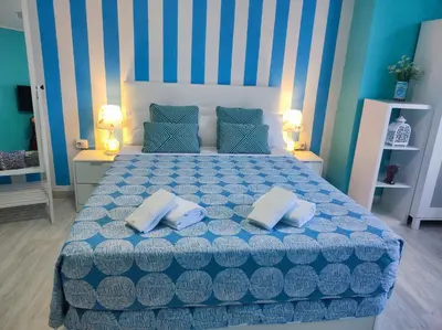 a bedroom with a blue and white bed with two pillows at Pensión Mar Azul in Santiago de Compostela