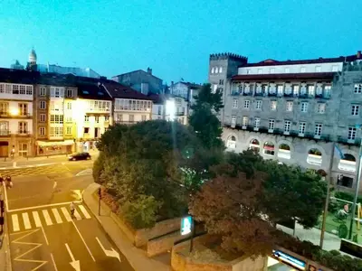 a view of a city at night with buildings at Pensión Mar Azul in Santiago de Compostela