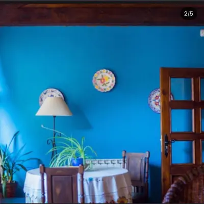 a blue room with a table and a blue wall at Casaquina in La Mezquita