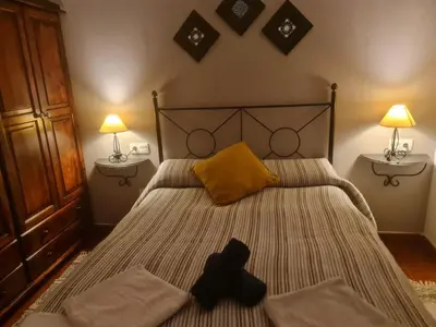 a bedroom with a bed with a teddy bear on it at apartamento Tita in Tapia de Casariego