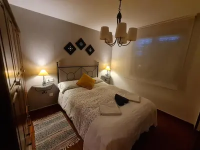 a bedroom with a bed with yellow pillows on it at apartamento Tita in Tapia de Casariego